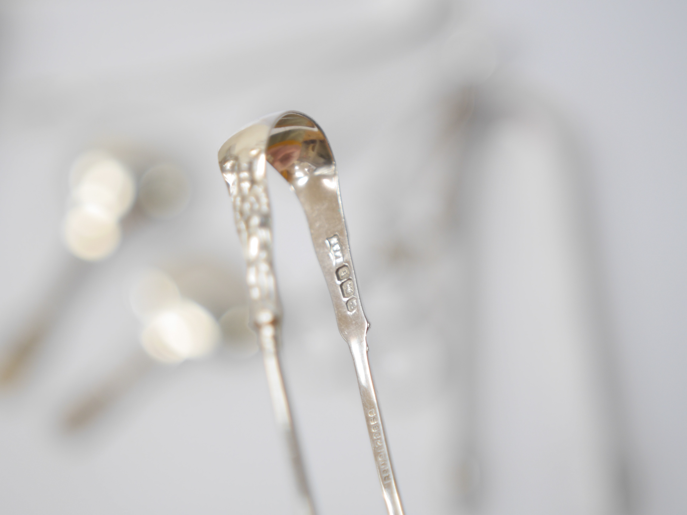 A pair of George III silver sugar tongs by Peter & William Bateman, London, 1807, 14.2cm, three other pairs of silver sugar tongs, one white metal pair, a pair of silver sugar nips and two 19th century silver caddy spoon